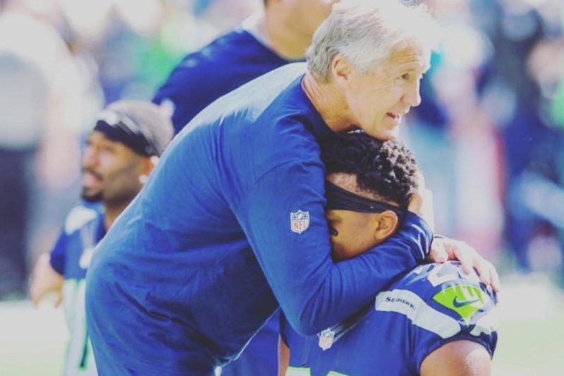 Seattle Seahawks coach Pete Carroll hugs running back C.J. Prosise. (Instagram/C.J. Prosise)