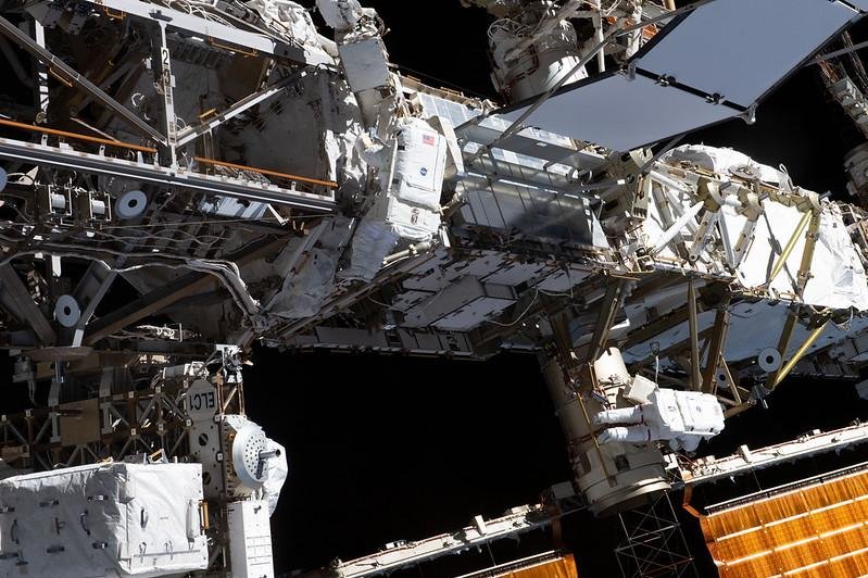 Expedition 70 flight engineers Loral O'Hara (C) and Jasmin Moghbeli (lower right) do maintenance work on the International Space Station during a spacewalk on November 1. A tool bag was lost during the work and is floating in orbit. Photo courtesy of NASA