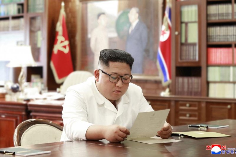 A photo released Sunday by North Korea’s KCNA shows Kim Jong Un reading a letter from U.S. President Trump, in Pyongyang, North Korea. Photo by KCNA/EPA