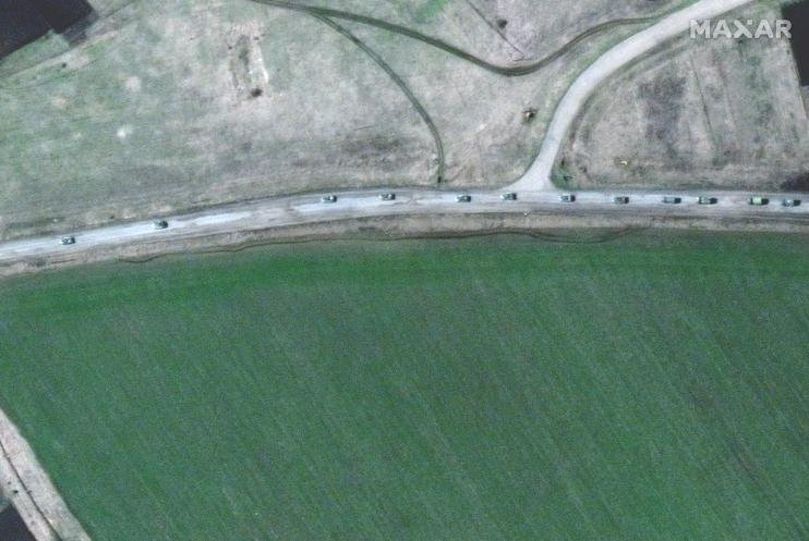 A handout satellite image made available by Maxar Technologies shows a convoy of armored military vehicles and trucks that extends for at least eight miles moving south through the Ukrainian town of Velykyi Burluk on Friday. Photo courtesy Maxar Technologies/EPA-EFE