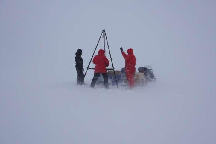 Scientists drill through the sea ice to measure temperature and salinity levels in Greenland's Young Sound. Photo by Soren Rysgaard