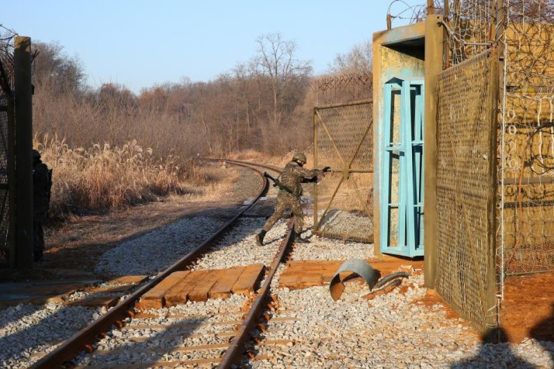 The border gate of rail tracks inside the demilitarized zone is opened for a South Korean train to pass through on Nov. 30, 2018. The train is carrying a delegation that will conduct a joint railway inspection with the North. Pool Photo/Yonhap