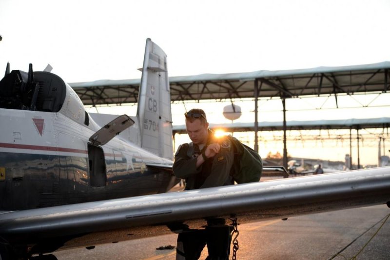 Capt. Roland Neal, 37th Flying Training Squadron Instructor Pilot, grabs his gear after a flight June 28, 2017, on Columbus Air Force Base, Mississippi. Photo by Airman 1st Class Keith Holcomb/U.S. Air Force