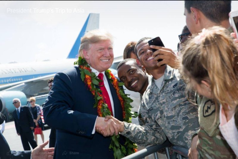 President Donald Trump takes a photo with U.S. Air Force members upon his arrival in Honolulu, Hawaii, on Friday. Photo by Shealah Craighead/White House/Facebook