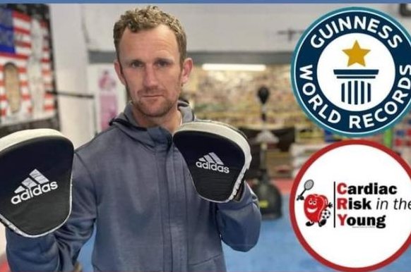 Mark Bebbington, a coach at the New Era Community Boxing Club in Northwich, England, held boxing pads for 500 rounds to break a Guinness World Record. Photo courtesy of&nbsp;New Era Community Boxing Club/Facebook