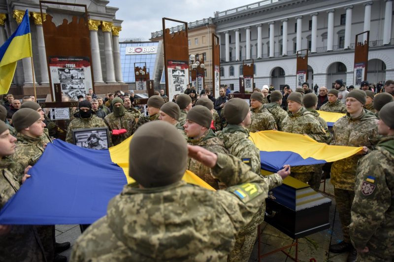 Ukraine's honor guard salutes at memorial service for four Ukrainian fighters who were killed during a combat mission in December, at Maidan Nezhalezhnosti Square in Kyiv, Ukraine, on Tuesday. Photo by Oleg Petrasyuk/EPA-EFE