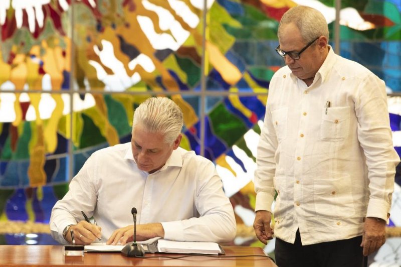 Cuban President Miguel Diaz-Canel signs the country's new Family Code Law, legalizing same-sex marriage, after voters overwhelmingly approved the referendum Sunday. Photo courtesy of government of Cuba.