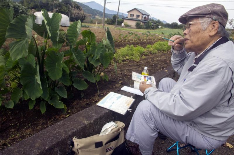 An elderly Japanese man practices his hobby of painting in a community garden in the city of Ashigara, Kanazawa prefecture, Japan, on Oct. 23, 2016. Photo by Everett Kennedy Brown/EPA