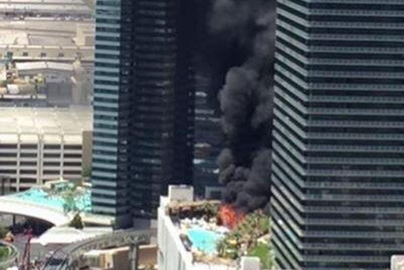 A two-alarm fire broke out at the Cosmopolitan Hotel in Las Vegas on Saturday, where it burned trees and cabanas at the pool area. Authorities said one person was hospitalized with injuries, Saturday, July 25, 2015. Photo: John Wells / YouTube