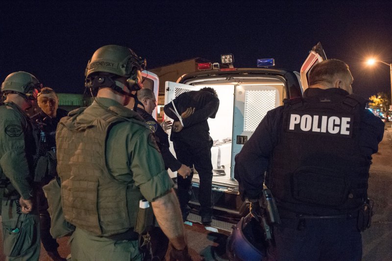 A Baltimore protester is loaded into a police van similar to the one in which Freddie Gray was riding when he sustained a serious head injury, law enforcement sources said. Photo by Ken Cedeno/UPI
