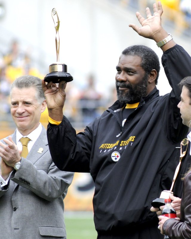 Pittsburgh Steelers president Art Rooney II applauds as former Steeler "Mean" Joe Greene waves to the crowd after receiving his Cleo Award trophy to celebrate the 30th anniversary of the Coke-a-Cola commercial at Heinz Field after receiving in Pittsburgh, Pennsylvania on November 15, 2009. UPI/Archie Carpenter