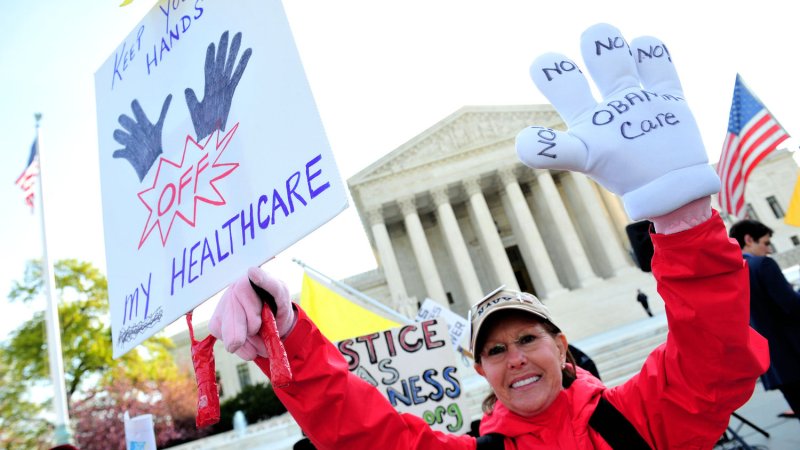 A protester demonstrates in front of the U.S. Supreme Court as the court hears it's third day of arguments on the constitutionality of President Obama's health care bill in Washington, D.C. on March 28, 2012. UPI/Kevin Dietsch | <a href="/News_Photos/lp/c72e8c473fcd04d7560b77ba56d37701/" target="_blank">License Photo</a>