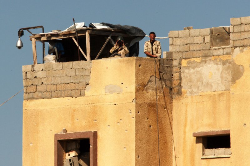 Egyptian soldiers observe from a watch tower on the border with Egypt, at the Rafah border crossing in Southern Gaza, on March 5, 2015. Rafah has been the target of an anti-smuggling operation after 33 Egyptian soldiers were killed in an October 2014 bombing in the northern Sinai Peninsula. File Photo by Ismael Mohamad/UPI