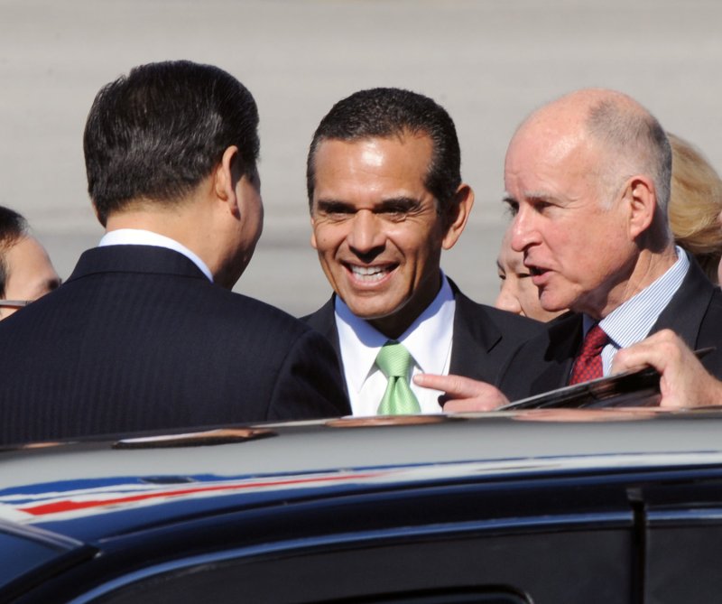 Chinese Vice President Xi Jinping (L) is greeted upon arrival at Los Angeles International Airport by California Gov. Jerry Brown (R) and Los Angeles Mayor Antonio Villaraigosa (C), Feb. 16, 2012. UPI/Jim Ruymen