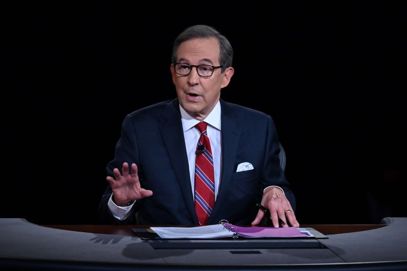 Debate moderator and FOX News anchor Chris Wallace directs the first presidential debate between Democratic presidential candidate former Vice President Joe Biden and President Donald Trump in Cleveland in 2020. Wallace, 74, announced his departure from Fox News Sunday. Pool Photo by Oliver Doulier/UPI
