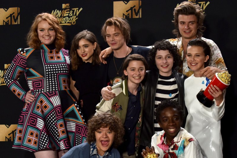 The cast of "Stranger Things" appear backstage with the Show Of The Year award at the MTV Movie & TV Awards on May 7. A new "Stranger Things" Season 2 poster features a look inspired by "Alien." File Photo by Christine Chew/UPI