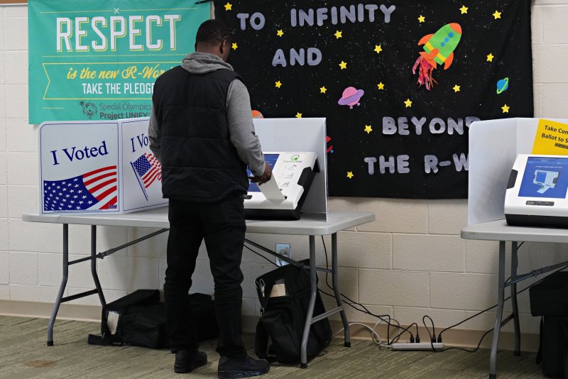 A voter casts a ballot in the Democratic presidential primary February 29 at the Dutch Fork High School in Irmo, S.C. On March 30, 1870, the 15th Amendment, granting African-American men the right to vote, was adopted into the U.S. Constitution. File Photo by Richard Ellis/UPI