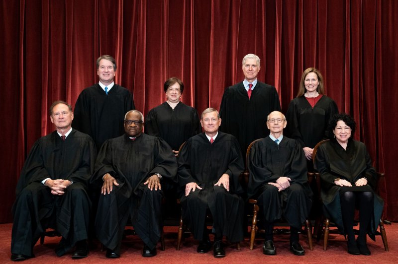 Members of the U.S. Supreme Court pose for a group photo Friday at the court in Washington, D.C. Seated, from left to right: Associates Justice Samuel Alito and Clarence Thomas, Chief Justice John Roberts and Associate Justices Stephen Breyer and Sonia Sotomayor. Standing, from left to right: Associate Justices Brett Kavanaugh, Elena Kagan, Neil Gorsuch and Amy Coney Barrett. Pool Photo by Erin Schaff/UPI