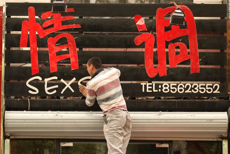 A Chinese man hangs letters on the facade of a new adult toy shop in Beijing on May 6, 2011. Sex us China's latest boom industry, providing 70 percent of the world's sex toys. UPI/Stephen Shaver