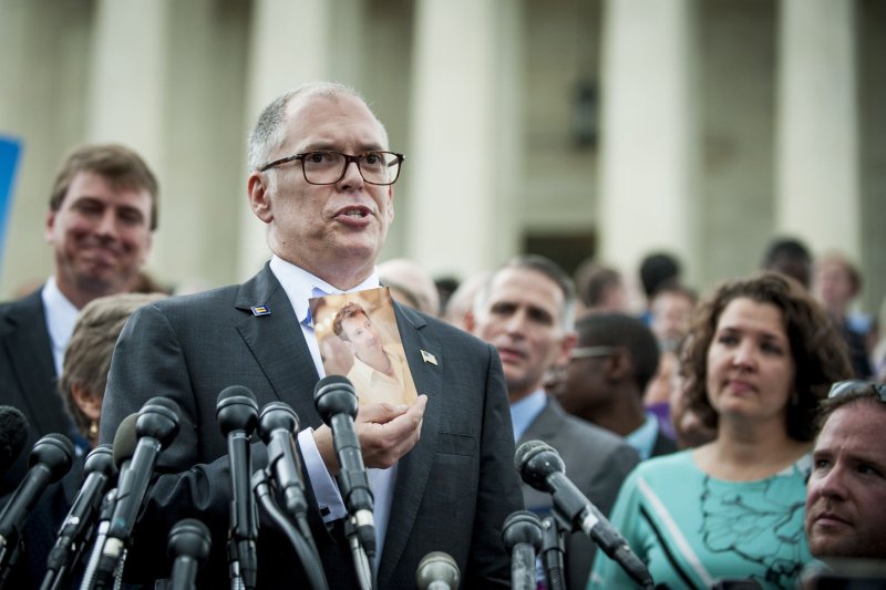 Jim Obergefell, lead plaintiff, in the same-sex marriage case, holds up a photograph of his former partner, John Arthur, in front of the U.S. Supreme Court on June 26, 2015. According to Gallup, 67 percent of U.S. adults believe same-sex couples should be validated by law. Photo by Pete Marovich/UPI