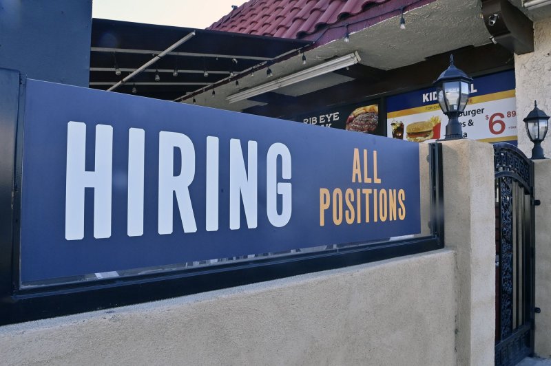 A "now hiring" sign is seen outside a fast food restaurant in Wilmington, California, on January 27, 2021. The Labor Department said on Thursday that the number of people filing for unemployment benefits for the first time remained stable at 209,000. File Photo by Jim Ruymen/UPI