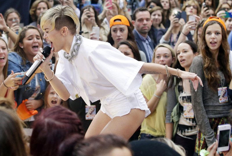 Miley Cyrus appears to smoke marijuana on stage at EMAs