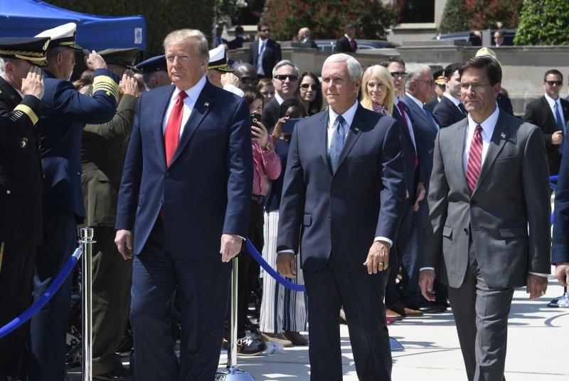 President Donald Trump (L) walks past an honor guard with the new Secretary of Defense Mark Esper (R) and Vice President Mike Pence (C), at the Pentagon, Thursday in Washington, DC. The Department of Defense has been without a full-time leader since former Secretary Jim Mattis resigned in December. Photo by Mike Theiler/UPI