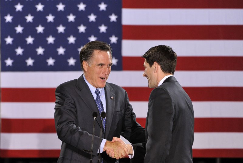 Republican Presidential hopeful Mitt Romney (L) shakes hands with Rep. Paul Ryan (R-WI) after being introduced at a rally on April 3 in Milwaukee. UPI/Brian Kersey