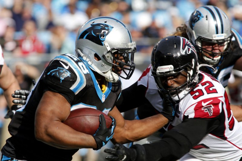 Carolina Panthers running back Jonathan Stewart, left, carries the ball for a first down against Atlanta Falcons linebacker Justin Durant in the first half of an NFL football game at Bank of America Stadium in Charlotte, North Carolina on December 13, 2015. UPI/Nell Redmond . | <a href="/News_Photos/lp/d2c0f3bdc83ed42b28aabd347a167ecd/" target="_blank">License Photo</a>
