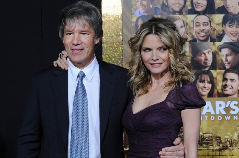 David E. Kelly with his wife Michelle Pfeiffer at the premiere of "New Year's Eve" on December 5, 2011. Kelly's new legal drama, "Goliath," which he calls "A whole new and unknown journey for me," is set to premiere on Amazon Friday. File Photo by Jim Ruymen/UPI | <a href="/News_Photos/lp/1ad1331968f62b76d0f3c82ce1d02b9a/" target="_blank">License Photo</a>