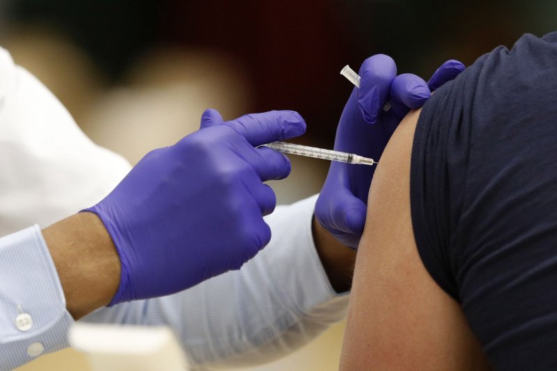 A health care worker administers the coronavirus vaccine to a school staff member in Medina, Ohio, Feb. 4. Photo by Aaron Josefczyk/UPI
