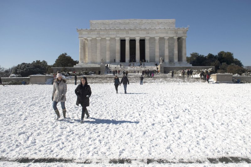 People visit the Lincoln Memorial after an overnight storm hit Washington, D.C., February 17, 2015. A President's Day snow storm dropped 3-6 inches of snow over the metro region. Photo by Kevin Dietsch/UPI | <a href="/News_Photos/lp/3a21e465bb28d170550b8aef6390dd27/" target="_blank">License Photo</a>