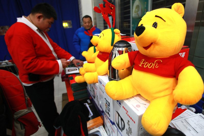 Chinese salesmen sell toys, including Winnie the Pooh, for Christmas at an international mall in Beijing on December 24, 2012. Christmas in China is typically celebrated for two of the country's favorite pastimes - eating and shopping. Although Christmas is not a traditional Chinese holiday, the brightly-colored lights of the holiday are attracting a growing number of Chinese fans. UPI/Stephen Shaver | <a href="/News_Photos/lp/0a2b13fe2f677af59d72f409b2ca7143/" target="_blank">License Photo</a>
