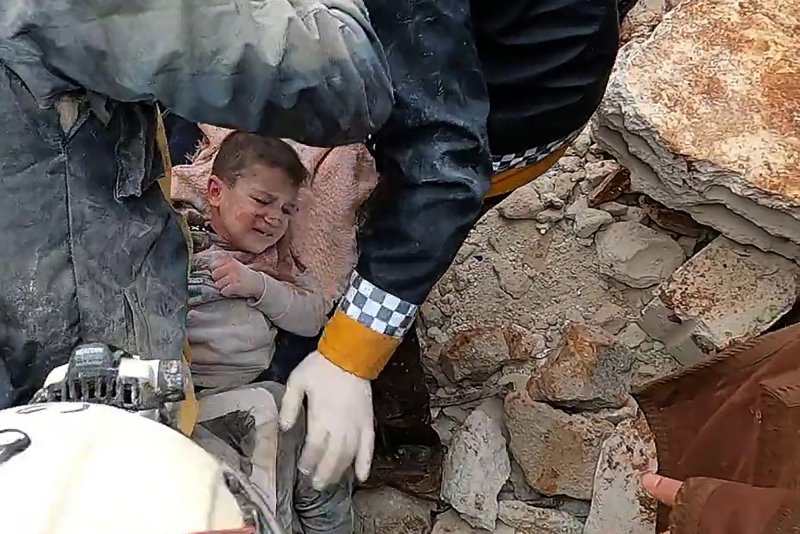 Rescuers pull a child out of the rubble after an earthquake in Idlib, Syria on Monday. Photo courtesy of Syria Civil Defense