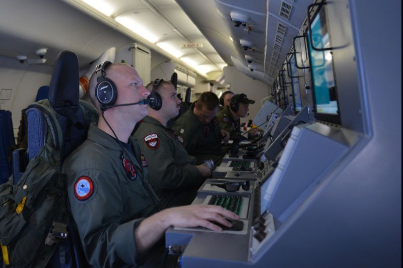 Crew members on board a P-8A Poseidon assigned to Patrol Squadron (VP) 16 man their workstations while assisting in search and rescue operations for Malaysia Airlines flight MH370, over the Indian Ocean, March 16, 2014. UPI/Eric A. Pastor/US Navy