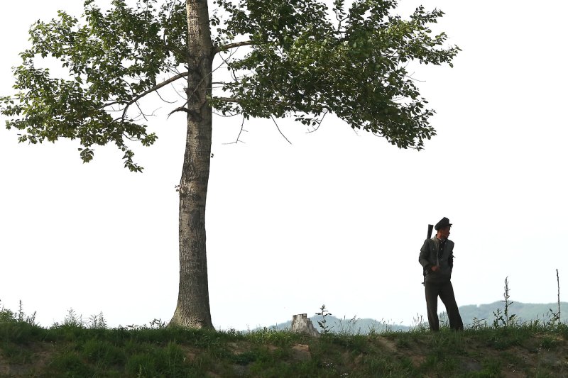 A North Korean solider patrols the border near the North Korean city Sinuiju, across the Yalu River from Dandong, China's largest border city with North Korea. On Wednesday, a committee said a writer still inside North Korea should be nominated for the Nobel Prize in literature for his account of life under the regime. Photo by Stephen Shaver/UPI
