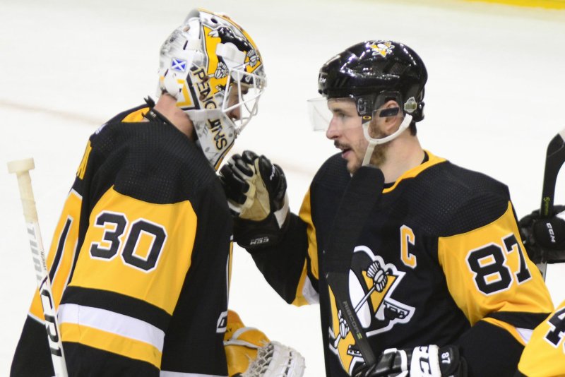 Pittsburgh Penguins center Sidney Crosby (87) congratulates Pittsburgh Penguins goaltender Matt Murray (30) on his 7-0 shutout against the Philadelphia Flyers in game one of the playoffs on April 11, 2018 at PPG Paints Arena in Pittsburgh. Photo by Archie Carpenter/UPI