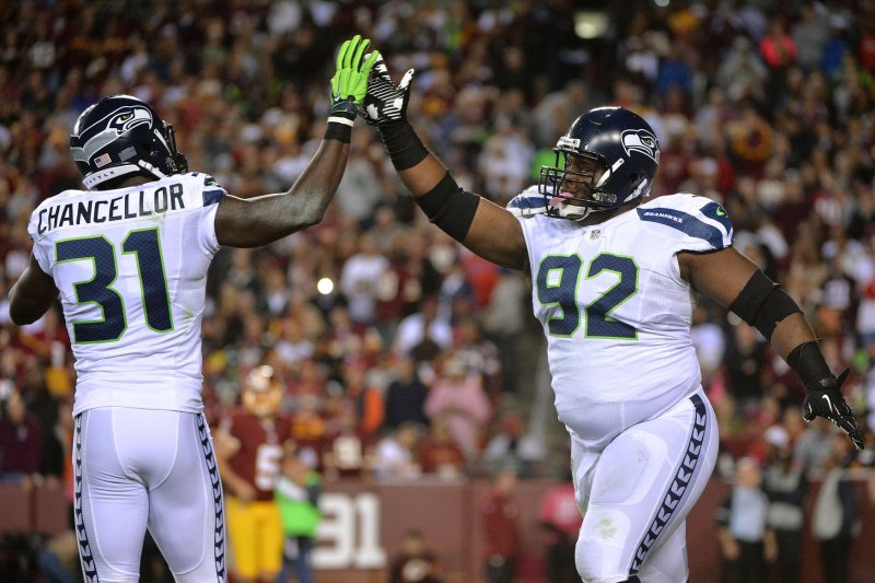 Seattle Seahawks strong safety Kam Chancellor (31) and Brandon Mebane celebrate after stopping the Washington Redskins during the third quarter at FedEx Field in Landover, Maryland on October 6, 2014. UPI/Kevin Dietsch
