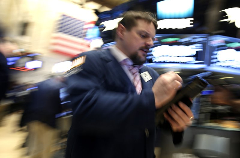 Traders work on the floor at the New York Stock Exchange on Wall Street in New York on February 17. The Dow Jones Industrial Average crossed the 21,000 threshold for the first time on Wednesday. Photo by John Angelillo/UPI