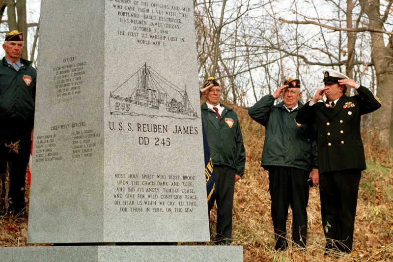 Retired Navy Chief Boatswain Stephen Heald of Georgetown, Maine, (R) blows the boatswains call during a cermony in Portland, Maine on November 14, 1998, at the just-installed monument to honor the men that died on the first United States warship sunk in World War II, the destroyer USS Reuben James. A German U-boat torpedoed the destroyer on October 31, 1941. File Photo by Lee K. Marriner/UPI
