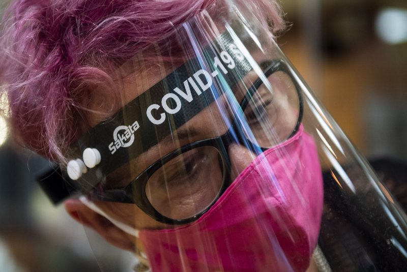 Large gaps around the sides, and sometimes the bottom or top of face shields, allowed respiratory droplets from other people to get to the face, potentially exposing the wearer to viruses, a recent study found. File Photo by Kevin Dietsch/UPI