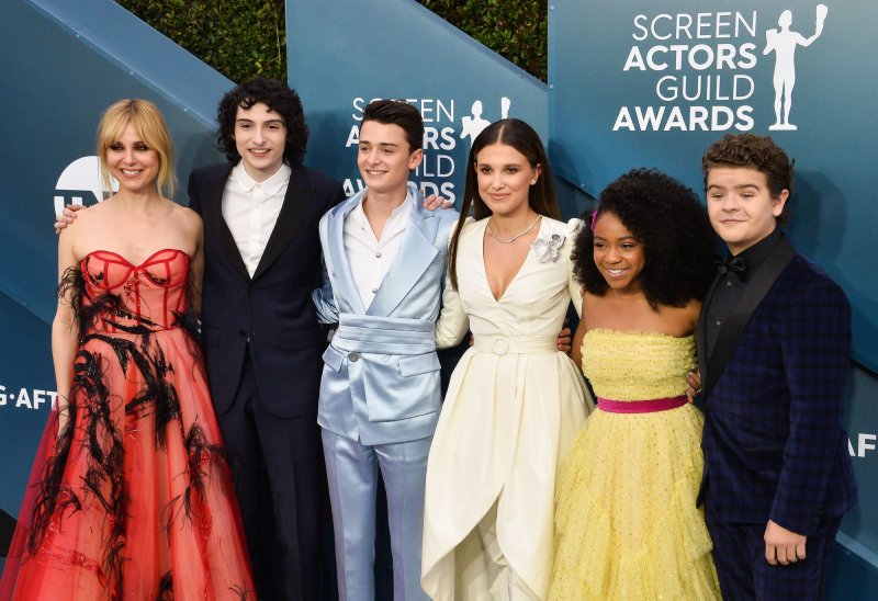 Left to right, Cara Buono, Finn Wolfhard, Noah Schnapp, Millie Bobby Brown, Priah Ferguson, and Gaten Matarazzo arrive for the 26th annual SAG Awards held at the Shrine Auditorium in 2020. File Photo by Jim Ruymen/UPI | <a href="/News_Photos/lp/0f02f5523fbe5b9e501fa1f0c62eae3e/" target="_blank">License Photo</a>