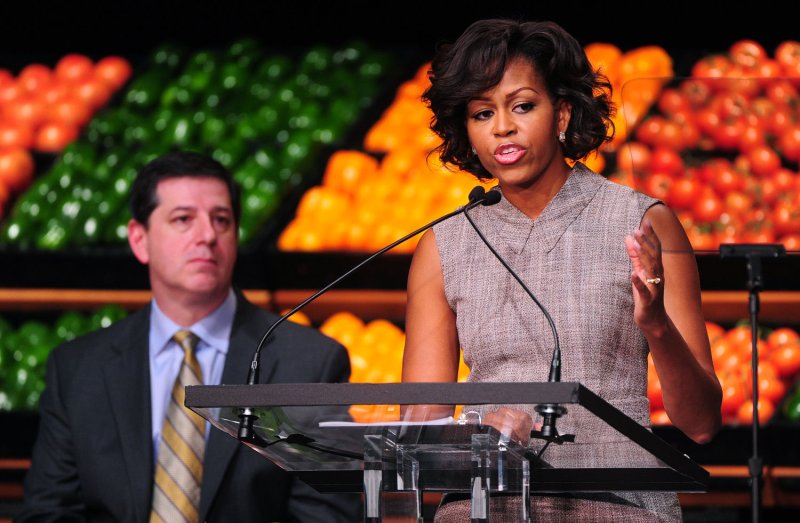 First Lady Michelle Obama speaks alongside Walmart CEO Bill Simon as she announces her support for Walmat's new health initiative in Washington on January 20, 2011. Walmart has announced they will cut the fat, sugar and sodium in some packaged foods and will lower the price of fresh fruits and vegetables. UPI/Kevin Dietsch
