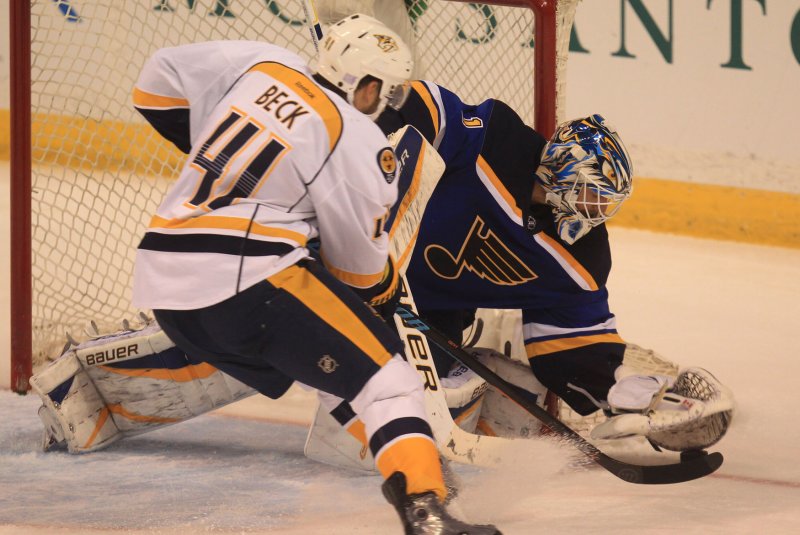 St. Louis Blues goaltender Brian Elliott gathers the loose puck away from Nashville Predators Taylor Beck in the third period at the Scottrade Center in St. Louis on November 8, 2014. Nashville won the game 2-1. UPI/Bil Greenblatt