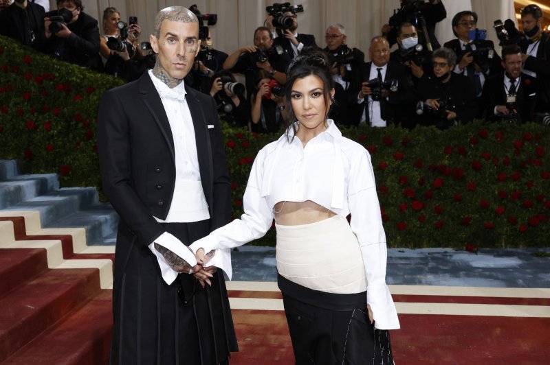 Travis Barker and Kourtney Kardashian arrive on the red carpet for The Met Gala in 2022. Blink-182 said they will postpone some of their shows in Europe as drummer Barker returns to the U.S. to address an "urgent family matter." File Photo by John Angelillo/UPI