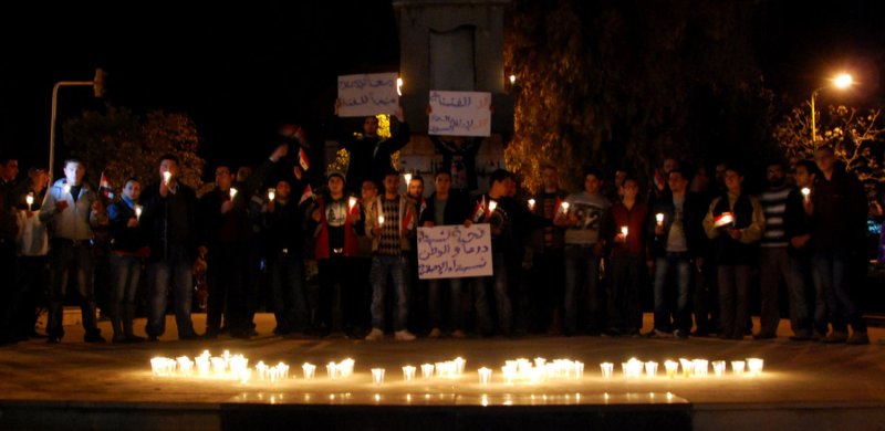 Anti-government protesters hold the Syrian flags and candles at Shuhada or (Martyrs) Square in Swaeda in the southern part of Syria on March 28, 2011. The demonstration was for the victims who were apparently killed by the security forces in Daraa and other cities along in the country. UPI/Ali Bitar