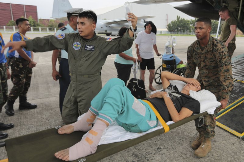 U.S. Marines carry an injured Filipino woman on a stretcher for medical attention, assisted by a Philippine Air Force airman at Vilamore Air Base, Manila, Republic of the Philippines Nov. 11. Super Typhoon Haiyan has impacted more than 4.2 million people across 36 provinces in the Philippines, according to the Philippine government's national disaster risk reduction and management council. UPI/Caleb Hoover/DOD