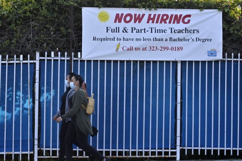 A "now hiring" banner is seen outside a private school in Los Angeles, California on January 27, 2021. The Labor Department said the economy added 263,000 jobs in November. File Photo by Jim Ruymen/UPI