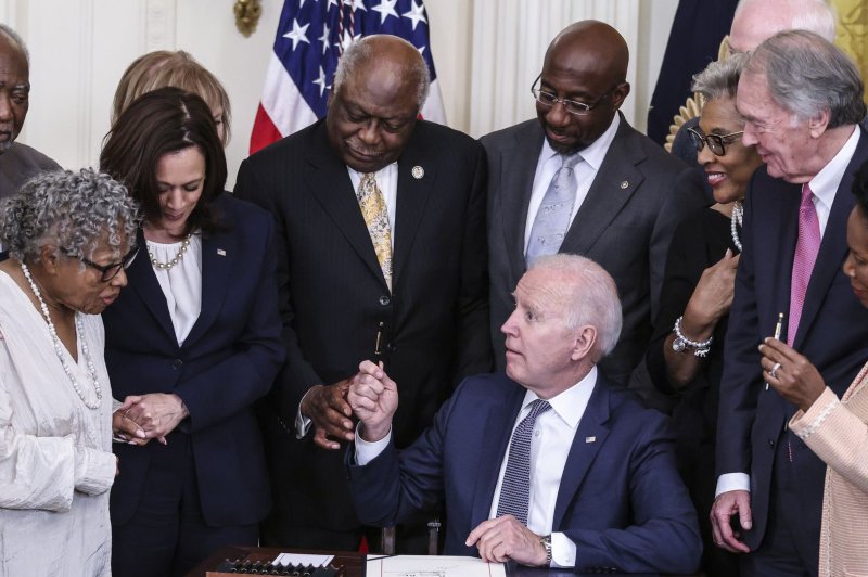 President Joe Biden signs the Juneteenth National Independence Day Act into law in the East Room of the White House in Washington, D.C., on Thursday. Pool Photo by Oliver Contreras/UPI | <a href="/News_Photos/lp/c84a99633eec914d745adf467b0ceb39/" target="_blank">License Photo</a>