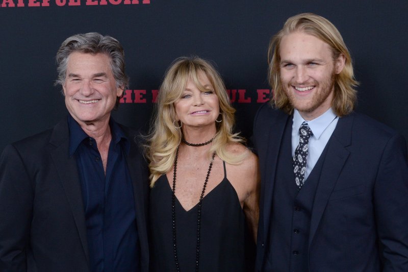 Wyatt Russell (R), pictured with Kurt Russell (L) and Goldie Hawn, stars in the horror film "Night Swim." File Photo by Jim Ruymen/UPI